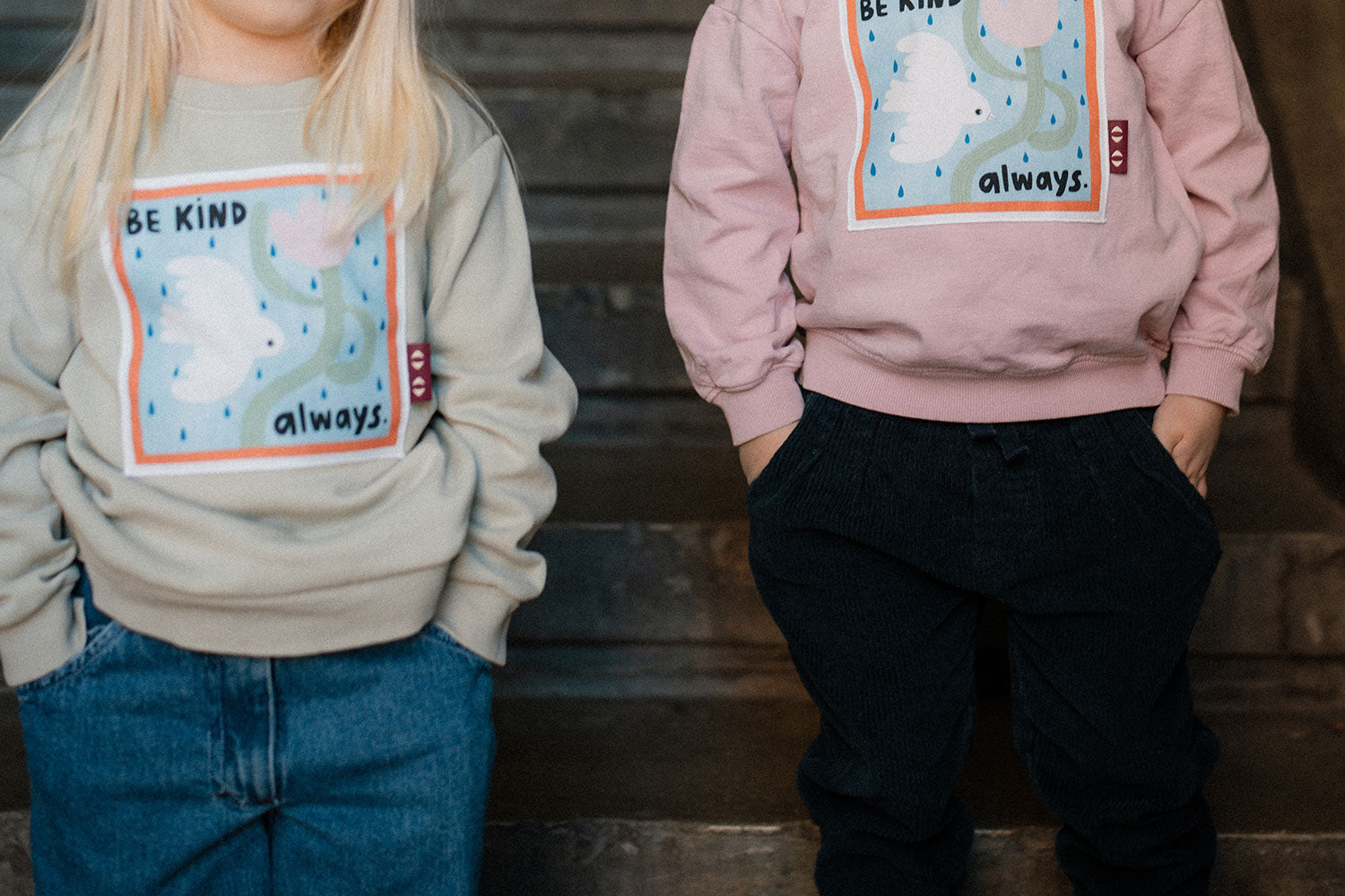 Two children wearing sweatshirts with Be kind-prints